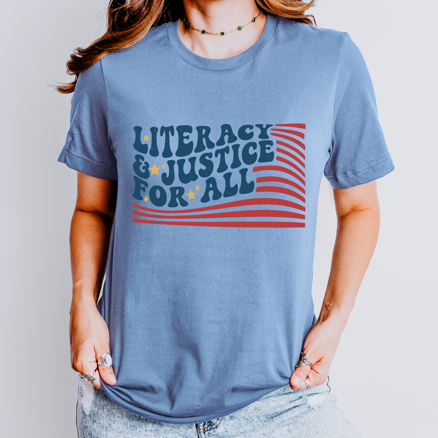 Person wearing a blue t-shirt with 'Literacy & Justice for All' text and design.