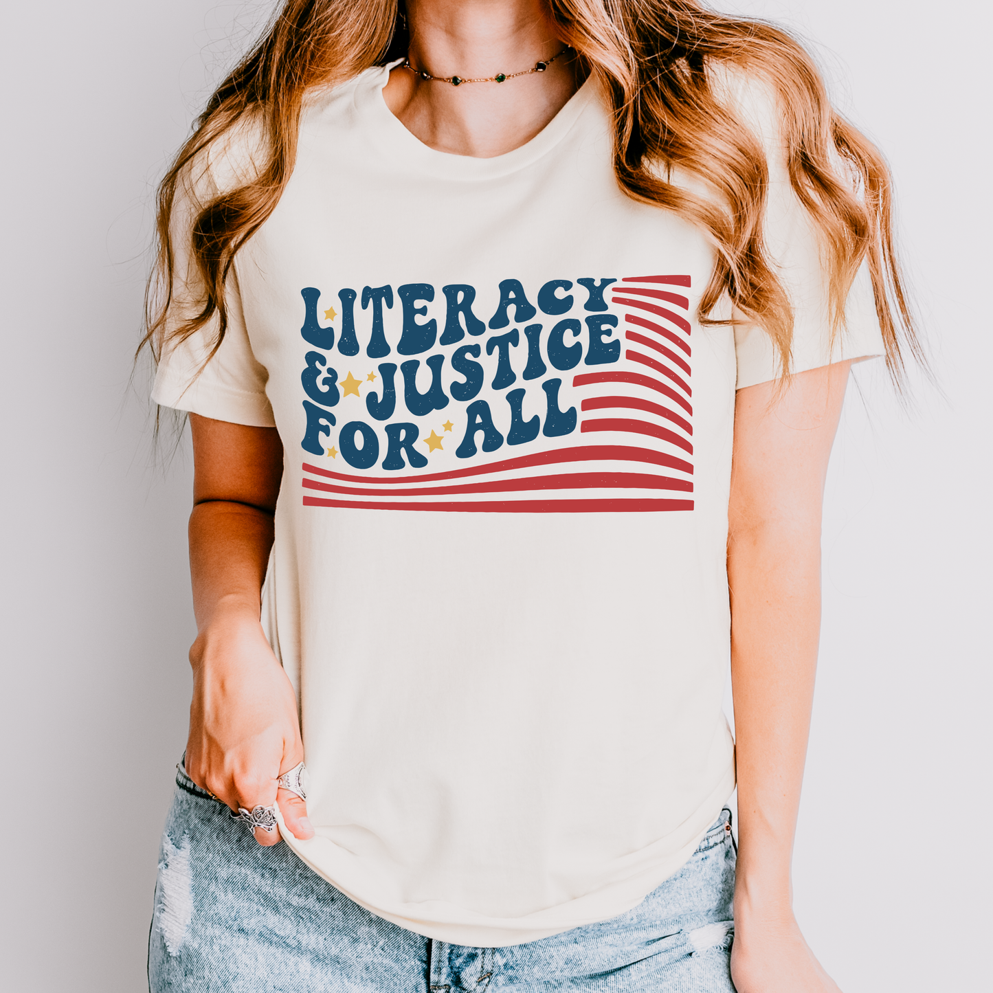 Person wearing a t-shirt with 'Literacy & Justice for All' text and design.