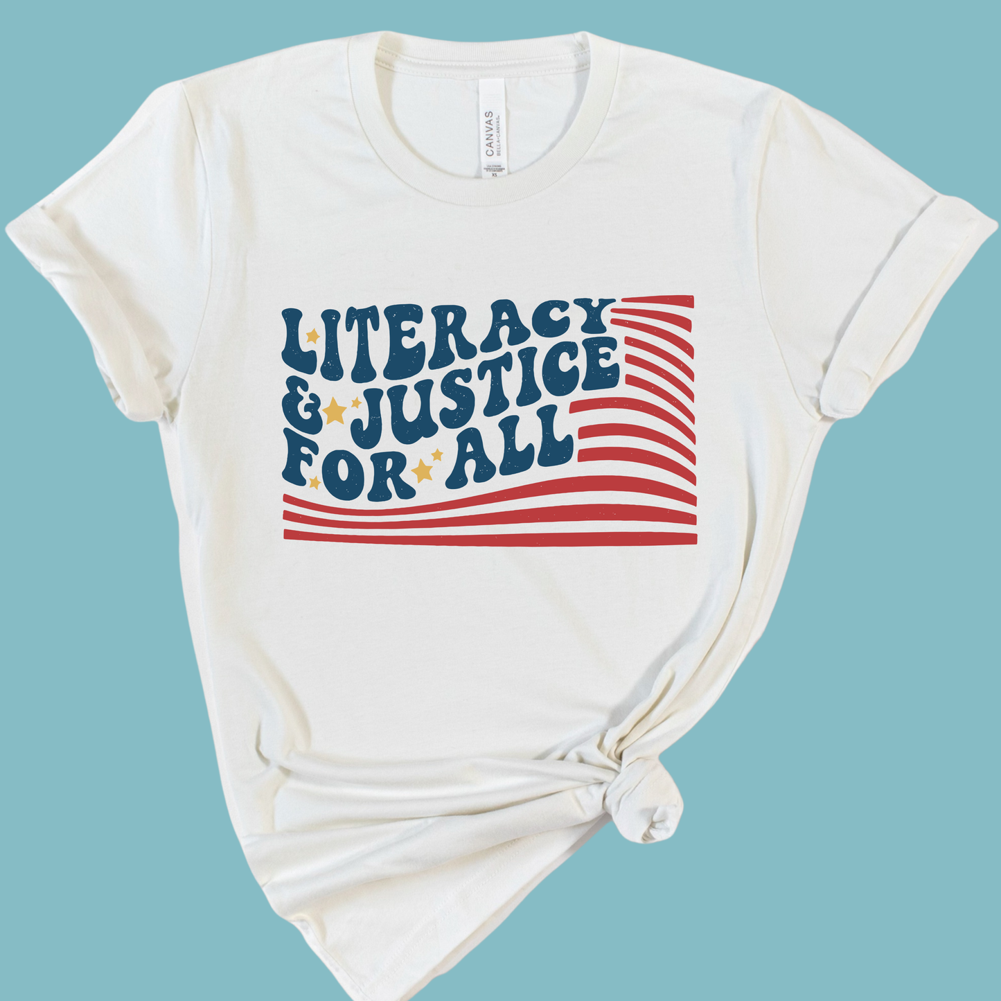 White t-shirt with 'Literacy & Justice for All' text and American flag design on a light blue background