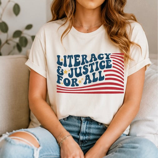 Person wearing a white t-shirt with 'Literacy & Justice for All' text design.